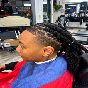 “Professional dreads retwist with clean side fade, neatly maintained locs styled at Fwresh Barbershop.”