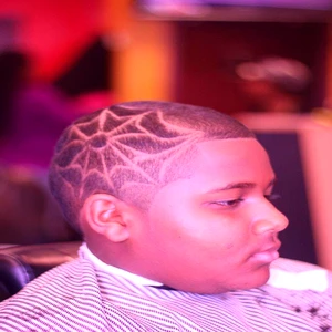 Kids haircut with creative shaved design and clean fade, styled professionally at Fwresh Salon & Barbershop