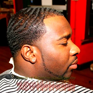 Men’s wave haircut with clean fade and sharp line-up at professional barbershop