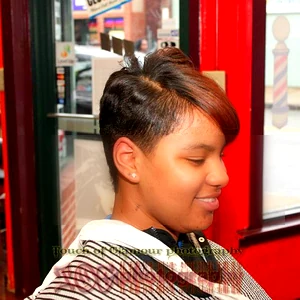 Woman with a modern short haircut inside a professional salon, showcasing women’s hair styling services.